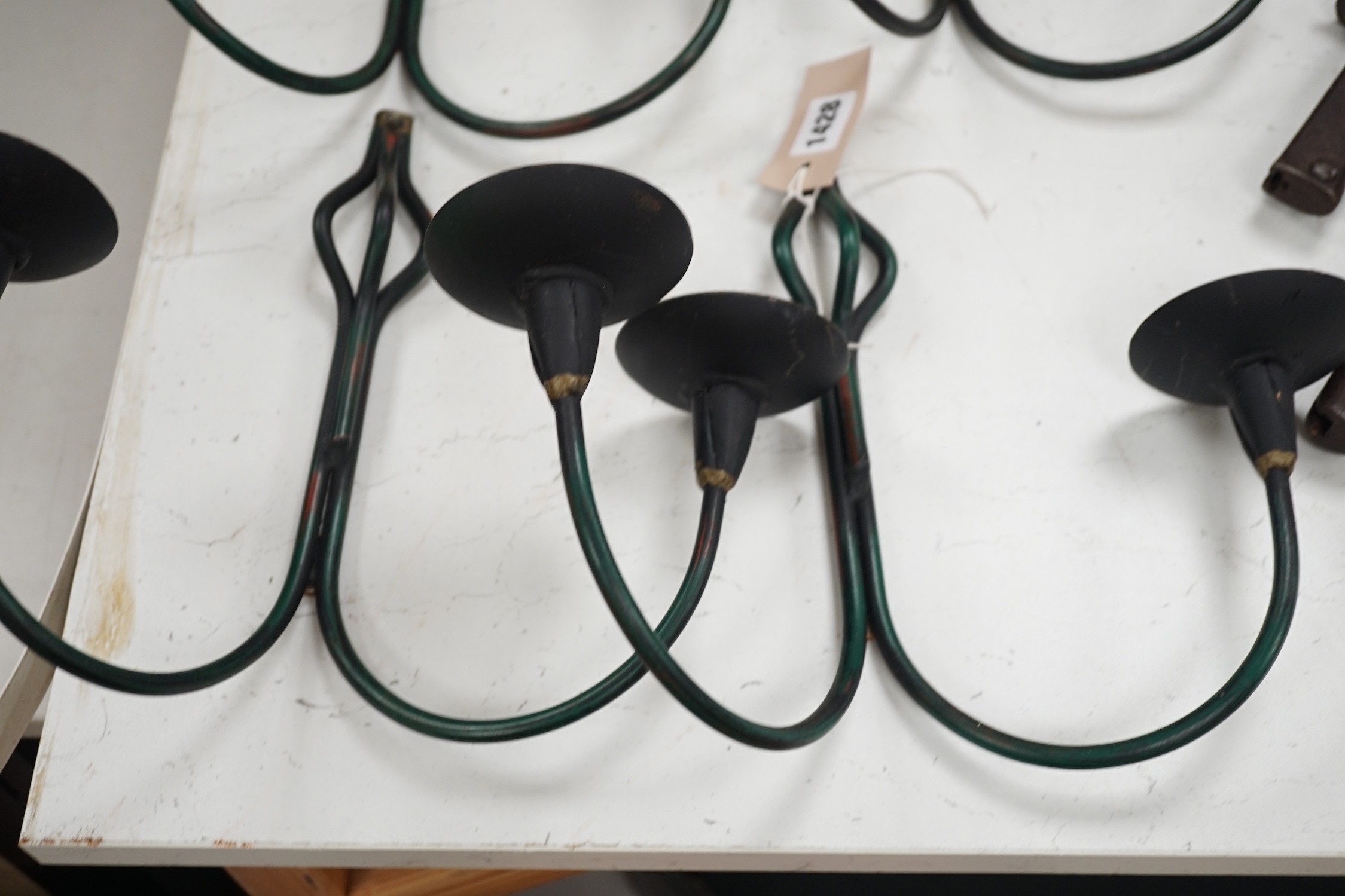 A set of four hand-forged twin-light wall sconces, 28cm long